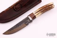 Hunter w/ Sambar Stag & Curly Maple