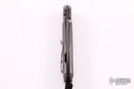 Large Sebenza 21 - Raindrop Damascus and Black Canvas Micarta