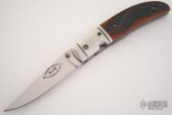 Serpentine Jigged Amber Bone Clip Point Linerlock